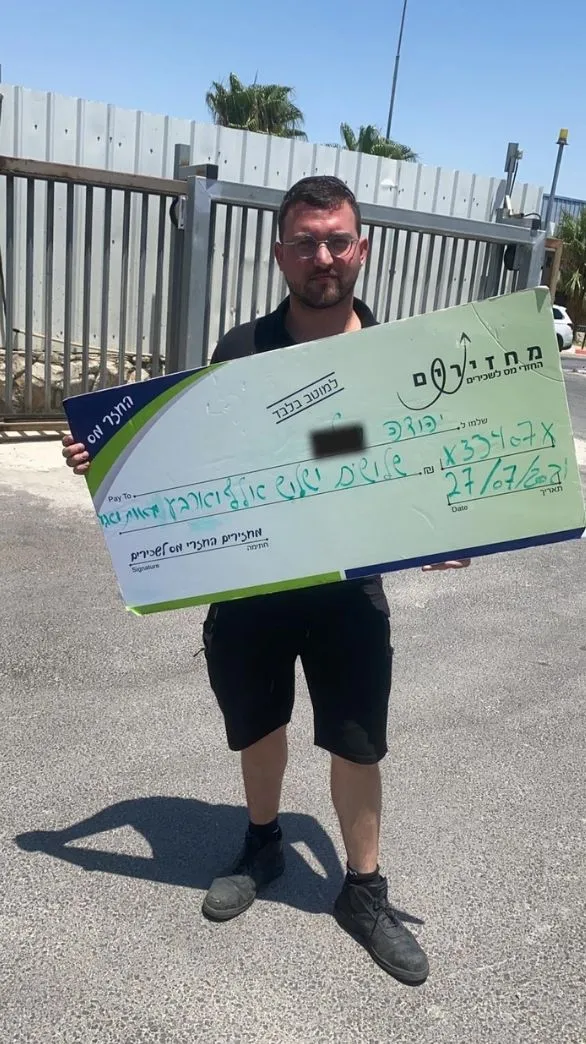 החזר מס ללקוחות שלנו - יהודה שקיבל 11,466 בהחזר מס לקוח שלנו והצטלם לאחר קבלת הכסף, לקוח מאושר שמחזיק את צ'ק גדול של הכסף שקיבל